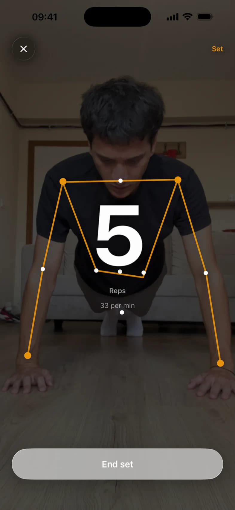 The PushRank counter mid-set: a live skeleton overlay traced on the person's shoulders, elbows and wrists, with the rep count and a per-minute rate over it.